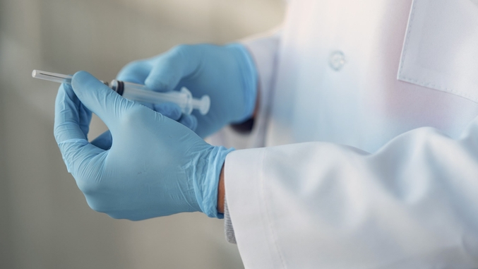 Image of doctor holding a syringe