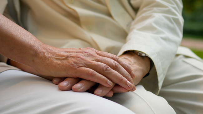 Image of Elderly Holding Hand to Provide Aid