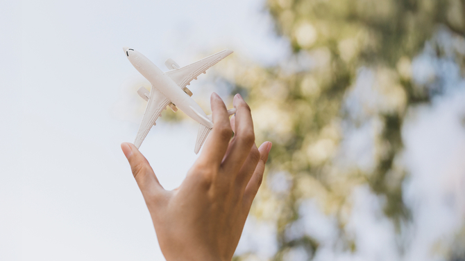 Image of hand holding a plane